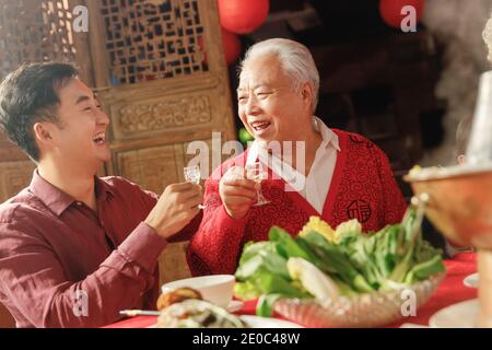 Happy father and son eat dinner drink Stock Photo