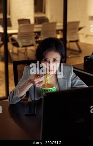 Young women in the office to work overtime Stock Photo