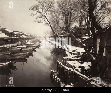 19th century vintage photograph - snow sene with boats along a canal in Tokyo, Japan, c.1880's Stock Photo