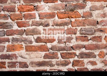 Old stone brick wall with cracks background Stock Photo