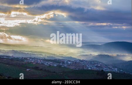 Overview of the Guadalupe town during a foggy sunrise, Caceres, Spain Stock Photo