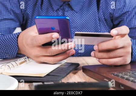 Man hand holding credit card and using smart phone shopping online  Stock Photo