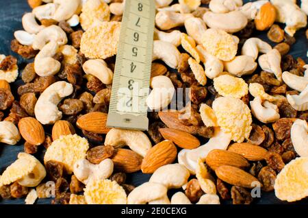 Cereals and centimeter tape is on a wooden background. Healthy lifestyle. Healthy food for weight loss Stock Photo