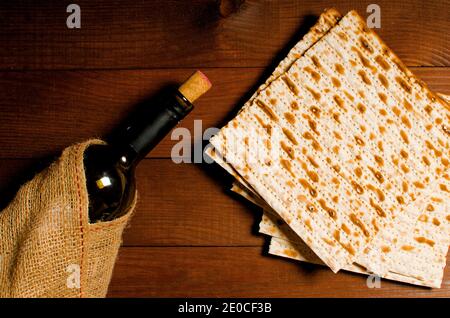 traditional Jewish kosher matzo for Easter pesah on a wooden table. Jewish Easter food. Spring. matzo and a bottle of red wine Stock Photo