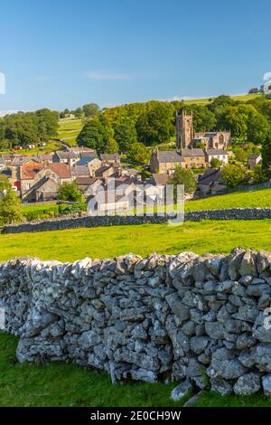 View of village church, cottages and dry stone walls, Hartington, Peak District National Park, Derbyshire, England, United Kingdom, Europe Stock Photo