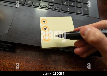 Check black in orange circles boxes on white paper. Stock Photo