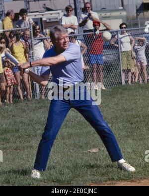 1976 - USA - Plains, Georgia, US - JIMMY CARTER takes his turn at bat during a softball game in his hometown. Carter was pitcher and captain of his team that was comprised of off duty U.S. Secret service agents and White House staffers. The opposing team was comprised of members of the White house traveling press and captained by the president's brother. Credit: Ken Hawkins/ZUMA Wire/Alamy Live News Stock Photo