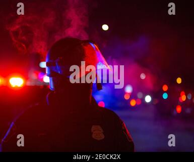 Minneapolis, Minnesota, USA. 31st Dec, 2020. An police officer exhales air in the cold Minnesota temps while holding a line. The BCA was investigating the crime scene of an officer involved shooting which took the life of 1 person. The scene of the shooting is 1 mile from where George Floyd was killed by police back in May of 2020. Credit: Chris Juhn/ZUMA Wire/Alamy Live News Stock Photo