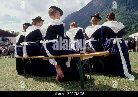 Germany /Bavaria / Bavarian Beerfestival Girls wearing traditional clothes and one girl took her shoes of . Stock Photo