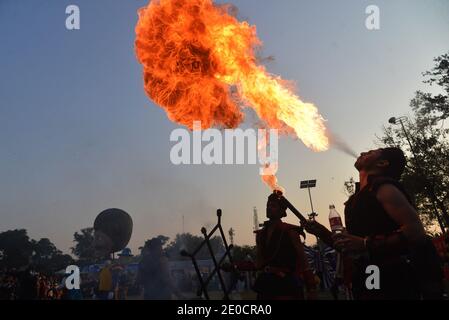 Lahore, Pakistan. 30th Dec, 2020. Pakistani large numbers of families sit in the ground take part during “Family Winters Festival” at Race Course Jilani Park in Provincial capital city Lahore. Families are enjoying with the Dinosaur model and breathing Fire from mouth show during “Family Winters Festival” at Race Course Jilani Park. (Photo by Rana Sajid Hussain/Pacific Press) Credit: Pacific Press Media Production Corp./Alamy Live News Stock Photo