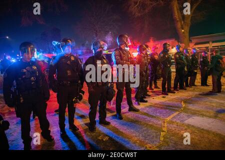 Minneapolis, Minnesota, USA. 31st Dec, 2020.  Protesters confront police that held a line while the BCA investigates the crime scene of an officer-involved shooting which took the life of 1 person. The scene of the shooting is 1 mile from where George Floyd was killed by police back in May of 2020. Credit: Chris Juhn/ZUMA Wire/Alamy Live News Stock Photo