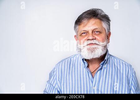 Eccentric senior man with funny expression portrait on background - Active and youthful old male Stock Photo