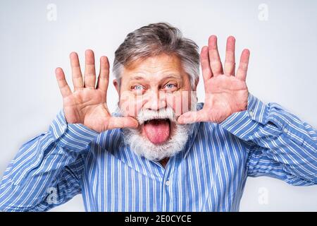 Eccentric senior man with funny expression portrait on background - Active and youthful old male Stock Photo