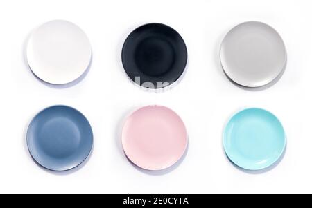 Set of six colorful empty plates isolated on white background top view. White, Black, Grey, Navy Blue, Pink, and Turquoise empty plates collection Stock Photo