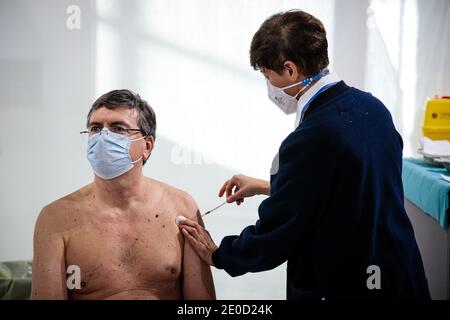 Bologna, Italy. 31st Dec, 2020. A health worker administers a syringe of the Covid vaccine on December 31, 2020 in Bologna, Italy. Italy began its Covid-19 vaccination campaign after the Pzifer-BioNtech doses arrived in EU countries on December 27. Italy has ruled out making the vaccine compulsory. Credit: Massimiliano Donati/Alamy Live News Stock Photo