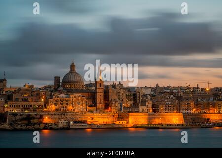 Valetta skyline with St. Paul's Anglican Cathedral and Carmelite Church at dusk , Malta Stock Photo