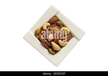 Bowl of natural mixed nuts, cashews, almonds, brazils, pecans and pistachios, unsalted nuts isolated on white background - for Christmas festive Xmas Stock Photo
