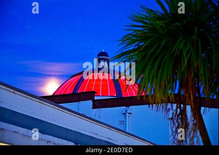 Red illuminated dome of the Marine Hall entertainment venue in Fleetwood at full moon Stock Photo