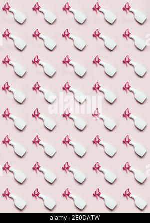 Top view of plastic bottles with window cleaner placed in even rows on pink background Stock Photo