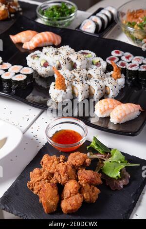 Various sushi and rolls placed on table in Asian restaurant Stock Photo