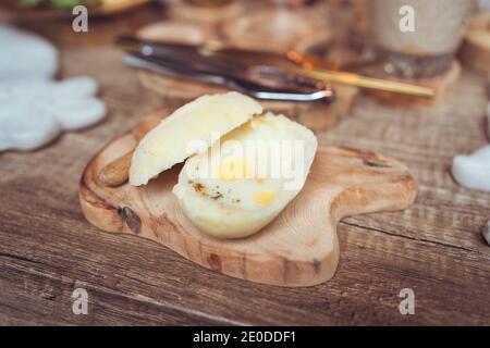 Closeup of traditional Asian bun with fried egg served on wooden board on table during breakfast in hotel of Taiwan Stock Photo