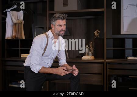 Stock photo of elegant business man wearing suit using his mobile phone. Stock Photo