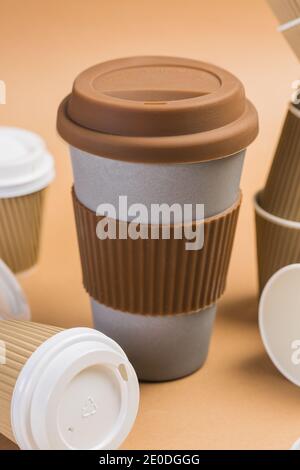 Various disposable cups of hot drinks placed on wooden table in cafe Stock Photo