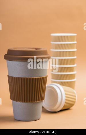 Various disposable cups of hot drinks placed on wooden table in cafe Stock Photo