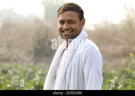Indian farmer standing in agricultural field Stock Photo