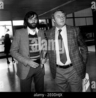 File photo dated 24/09/73 of Manchester United footballer George Best (left) and then manager Tommy Docherty at Heathrow Airport, in London, before leaving for Lisbon, Portugal. Mr Docherty has died at the age of 92 following a long illness. Stock Photo