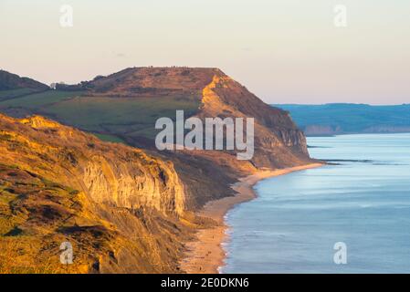 Charmouth, Dorset, UK.  31st December 2020.  UK Weather.  View of Golden Cap  at Charmouth on the Dorset Jurassic Coast at the end of a cold sunny day shortly before sunset on the last day of 2020.  Picture Credit: Graham Hunt/Alamy Live News Stock Photo