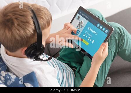 Remote learning concept with boy using laptop. E-learning, math exercise. Stock Photo