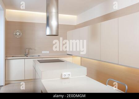 Modern kitchen minimalictic interior with beige artificial stone pannels. Kitchen design concept Stock Photo