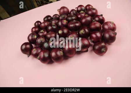 sweet red onions on background Stock Photo