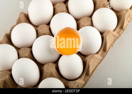 Raw chicken eggs in egg box on a white background Stock Photo