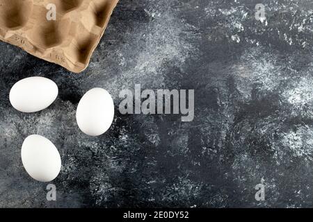 Three raw chicken fresh eggs on a marble background Stock Photo