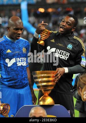 Olympique de Marseille's goalkeeper Steve Mandanda with the trophy celebrates their victory after winning the French League Cup Final football match Lyon vs. Marseille at the Stade de France in Saint-Denis, north of Paris, on April 14, 2012. Marseille won 0-1. Photo by Christian Liewig/ABACAPRESS.COM Stock Photo