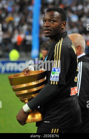 Olympique de Marseille's goalkeeper Steve Mandanda with the trophy celebrates their victory after winning the French League Cup Final football match Lyon vs. Marseille at the Stade de France in Saint-Denis, north of Paris, on April 14, 2012. Marseille won 0-1. Photo by Christian Liewig/ABACAPRESS.COM Stock Photo