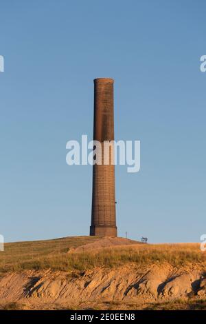 The sun sets at the Anaconda Smelter Stack in Anaconda Montana. Built in 1918 as part of the former Anaconda Copper Mining Company’s Washoe Smelter, t Stock Photo