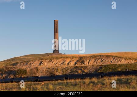 The sun sets at the Anaconda Smelter Stack in Anaconda Montana. Built in 1918 as part of the former Anaconda Copper Mining Company’s Washoe Smelter, t Stock Photo