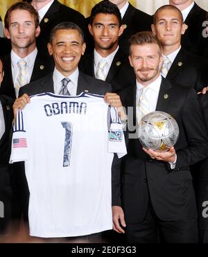 U.S. President Barack Obama holds up a jersey given to him by LA Galaxy while welcoming members of the Major League Soccer champions including David Beckham (R) to the White House to honor their 2012 season and their MLS Cup victory in the East Room of the White House in Washington, DC, USA on May 15 2012. Photo by Olivier Douliery/ABACAPRESS.COM Stock Photo