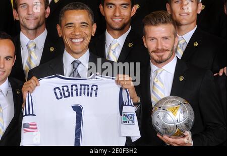 U.S. President Barack Obama holds up a jersey given to him by LA Galaxy while welcoming members of the Major League Soccer champions including David Beckham (R) to the White House to honor their 2012 season and their MLS Cup victory in the East Room of the White House in Washington, DC, USA on May 15 2012. Photo by Olivier Douliery/ABACAPRESS.COM Stock Photo