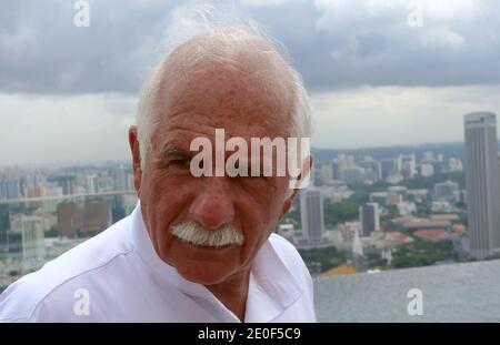 Israeli-born architect Moshe Safdie at Marina Bay Sands Resort in Singapore in 2010. Developed by Las Vegas Sands, it is billed as the world's most expensive standalone casino property at S$8 billion, including cost of the prime land. The resort features a 2,561-room hotel, a 120,000 m2 convention-exhibition centre, the 74,000 m2 The Shoppes at Marina Bay Sands mall, a museum, two large theatres, seven celebrity chef restaurants, two floating Crystal Pavilions, an ice skating rink, and the world's largest atrium casino with 500 tables and 1,600 slot machines. The complex is topped by a 340m-lo Stock Photo