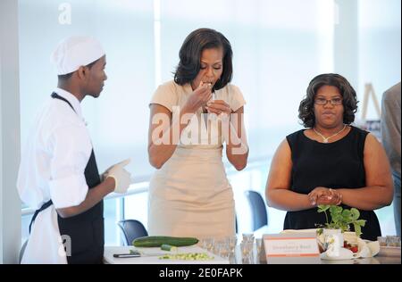 First Lady Michelle Obama tastes food that students make for the lunch with the NATO leaders Spouses at the Gary Corner Youth Center in Chicago, Illinois, IL, US on May 20, 2012. Photo by Olivier Douliery/ABACAPRESS.COM Stock Photo