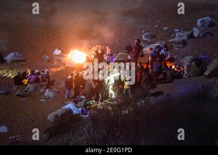 Eype, Dorset, UK.  31st December 2020. A large group of New Years Eve revellers breaching Covid-19 rules and rule of six to have a party on the beach at Eype in Dorset.  It is estimated their were 20-30 people grouped close together in the tier 3 area.  Picture Credit: Graham Hunt/Alamy Live News Stock Photo