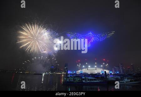 Fireworks and drones illuminate the night sky over London as they form a light display as London's normal New Year's Eve fireworks display was cancelled due to the coronavirus pandemic. Stock Photo