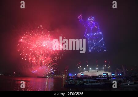 Fireworks and drones illuminate the night sky over London as they form a light display as London's normal New Year's Eve fireworks display was cancelled due to the coronavirus pandemic. Stock Photo