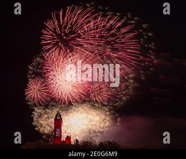 Stirling, Scotland, UK. 1st Jan, 2021. Pictured: Hogmanay pyrotechnic spectacular closes off 2020 and brings in 2021 with a bang as colourful explosions burst lighting up the new year night sky 600feet above the Wallace Monument in Stirling. Due to the coronavirus (COVID19) pandemic the show will be live streamed on TV and online since Scotland is in phase 4 lockdown. Edinburgh based events company, 21CC Events Ltd, pyrotechnic specialists have spent the last few days setting up the show including powerful projection lights for the monuments facade. Credit: Colin Fisher/Alamy Live News Stock Photo