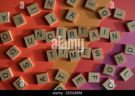 Uncertain Times, words surrounded by random alphabet letters Stock Photo