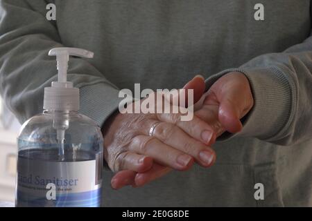 Woman using hand sanitiser, selective focus Stock Photo